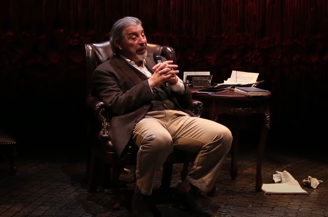 Max McLean sitting in an armchair with a microphone after the opening night of The Screwtape Letters