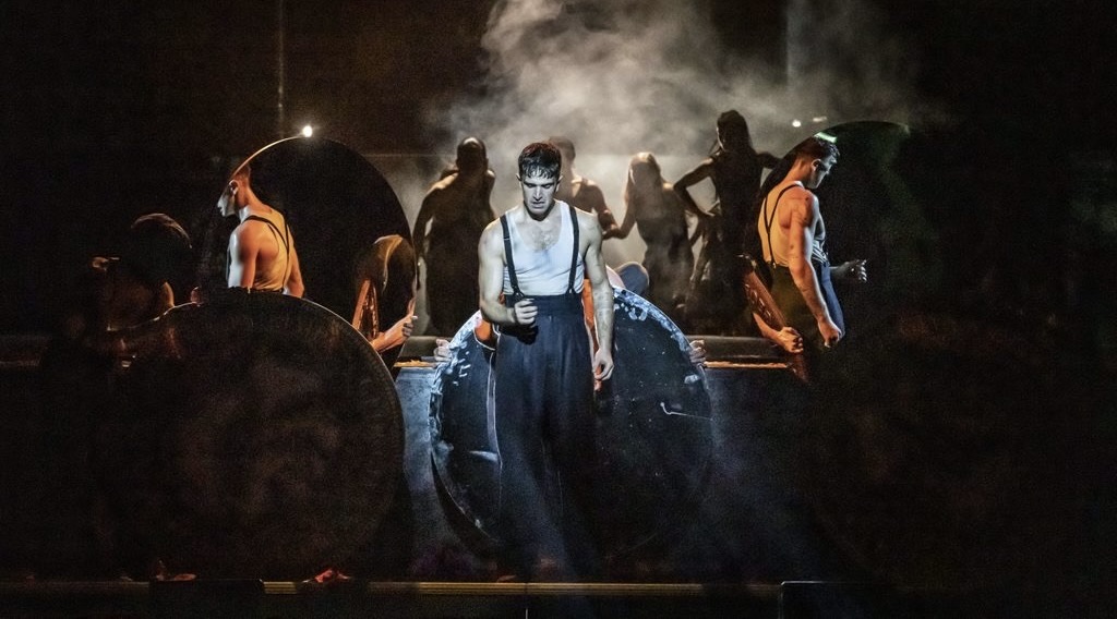 A man performs on stage amid smoke