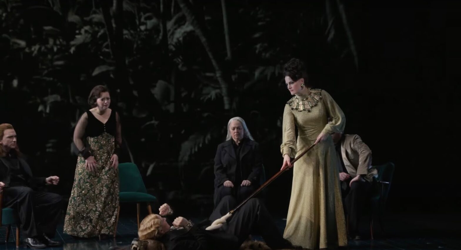 A group of people are playing a scene in a theater