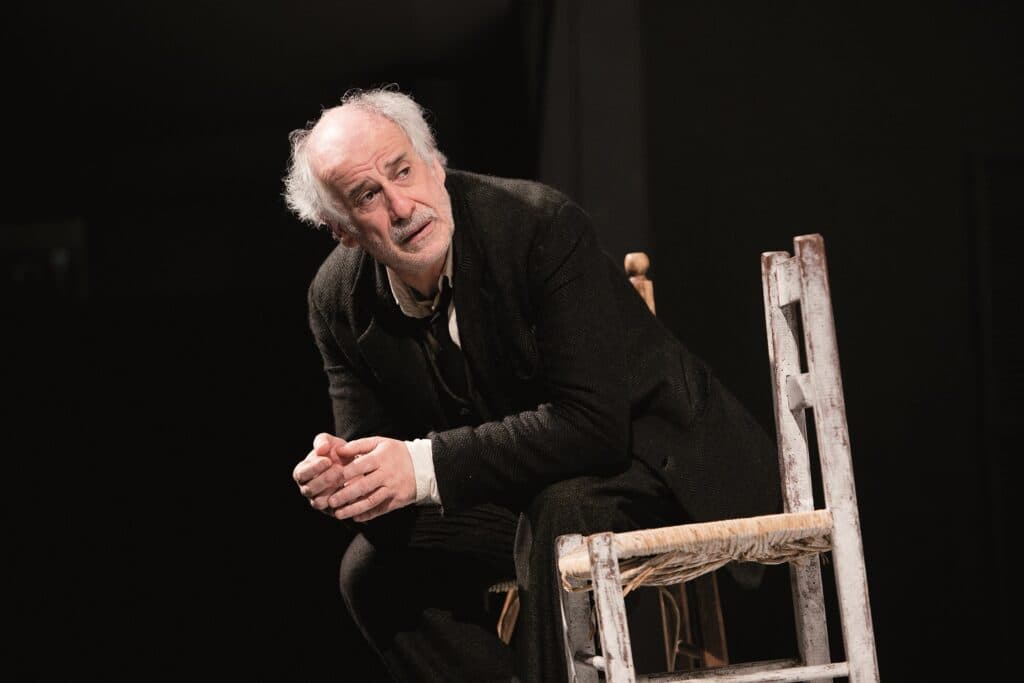Toni Servillo sitting on a chair in ‘Inner Voices’ (Le voci di dentro)